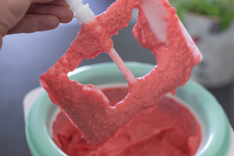 Making ice strawberry yogurt in an ice cream machine